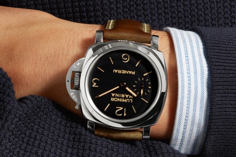 A close-up of a man's hand wearing a Panerai Luminor Marina.